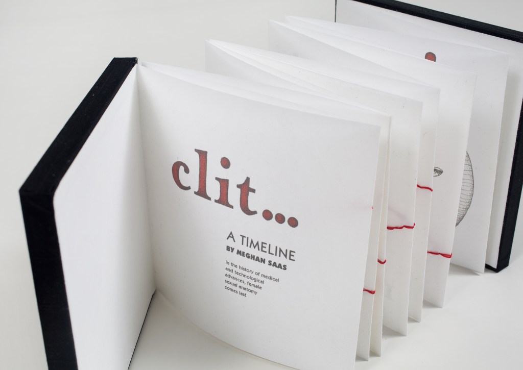 Photo of book standing open on table, showing title page