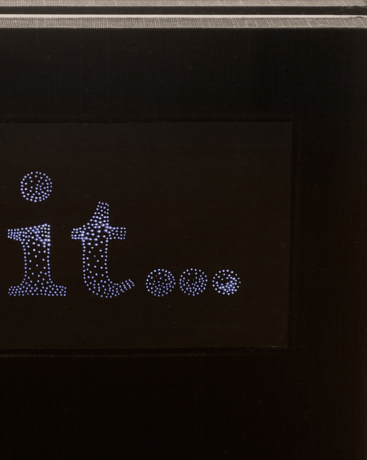 Detail image of Clit...A Timeline book - black cover with stippled letters "it..." lit from within